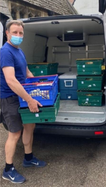 Volunteer loading crates into a delivery van